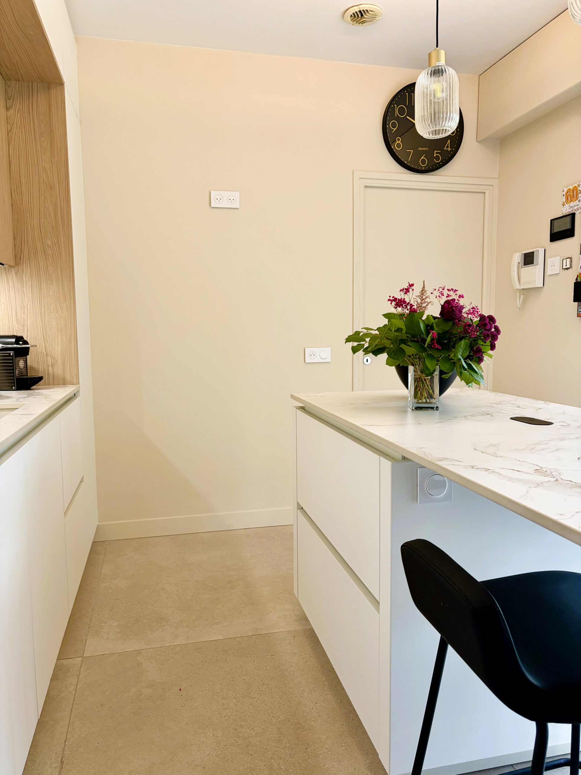 Cuisine aménagée sur mesure avec colonnes intégrées four et réfrigérateur dans un projet contemporain à Nantes