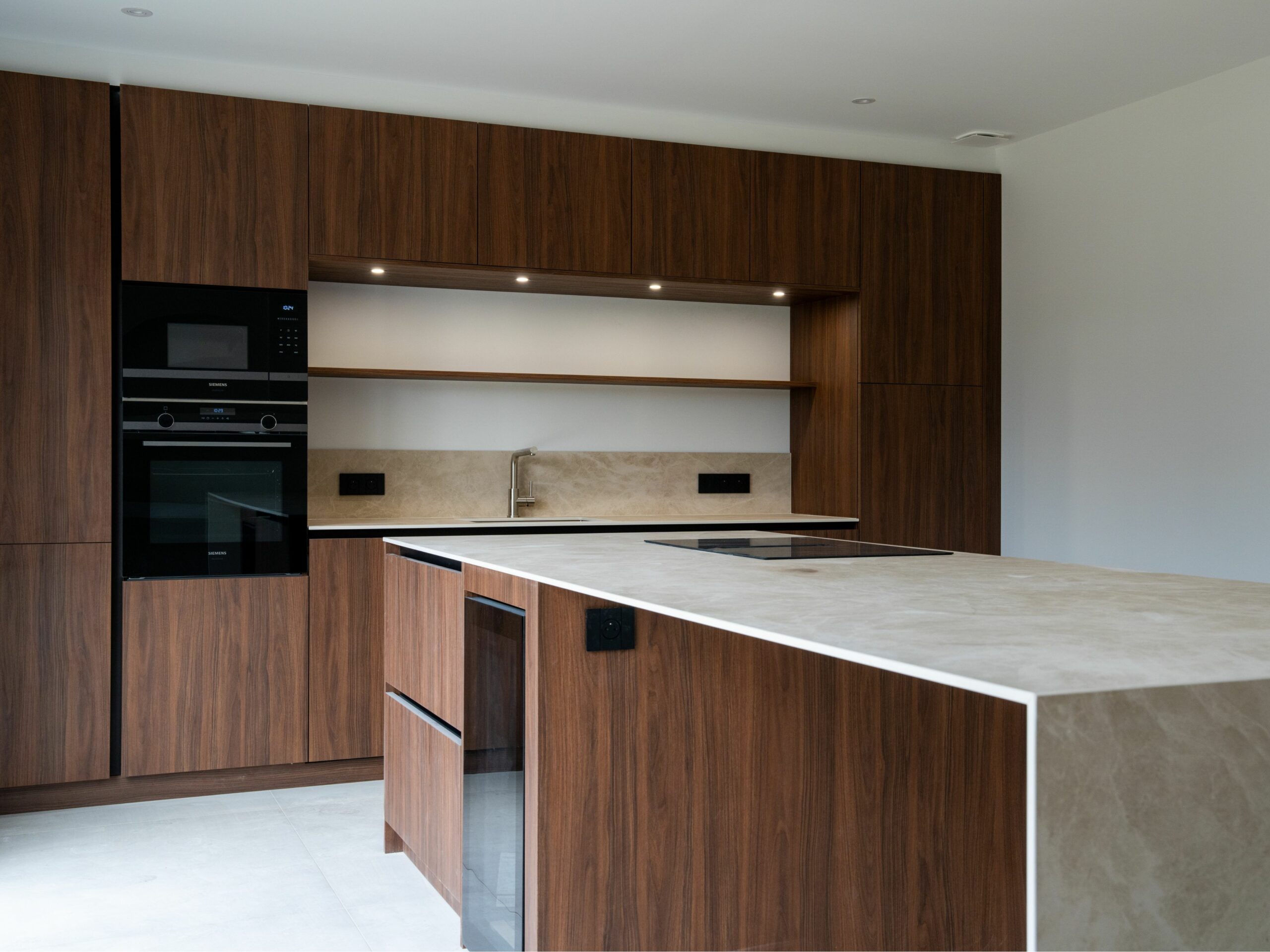 Îlot central avec cave à vin encastrée et plaque aspirante Siemens dans une cuisine ARMONY CUCINE à La-Chapelle-sur-Erdre